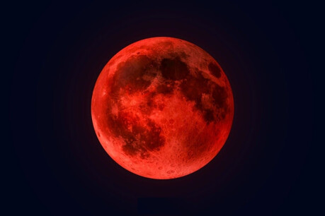 The moon appears red due to a total lunar eclipse on March 3, 2026.